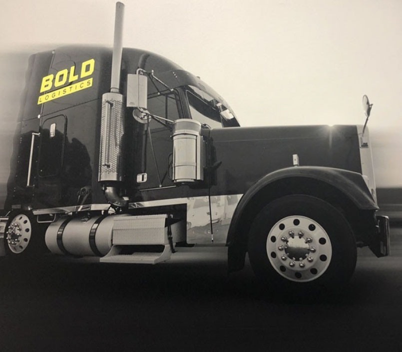 Black 18 wheeler with the Bold Logistics logo on the side.